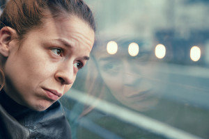 Woman in streetcar alone and depressed