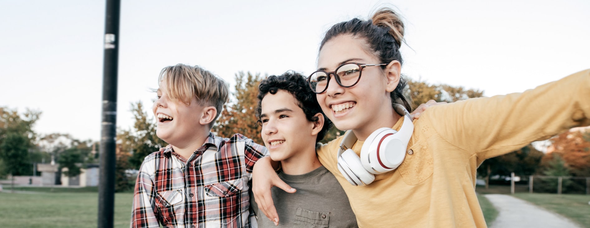 three children smiling together