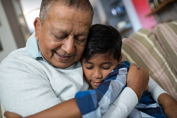 Boy embracing grandfather