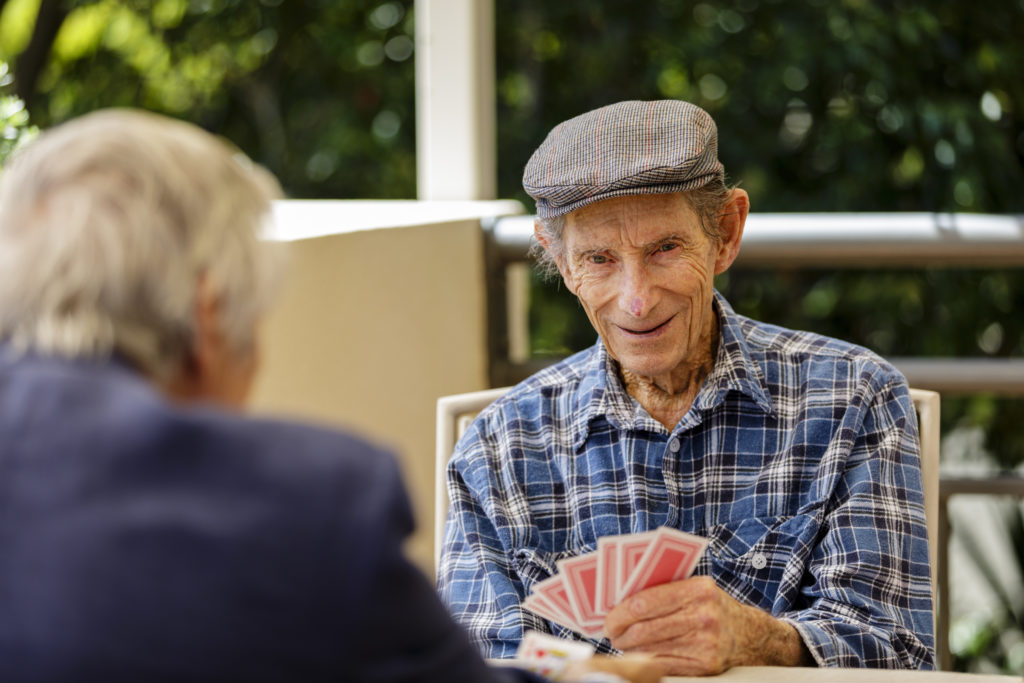 Two older men playing cards