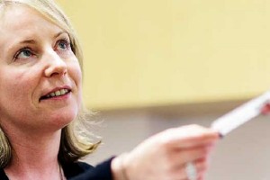 Woman hands syringe to someone