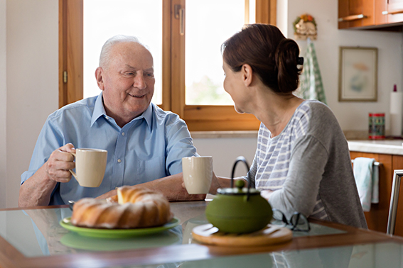 Female caregiver helping senior man
