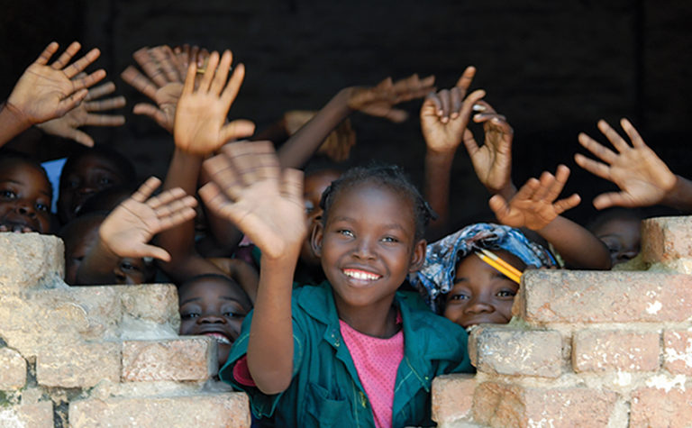 Several African children waving hands in Tchad