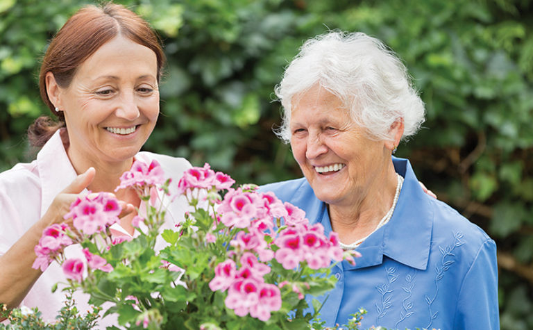 Gardening – senior woman with flowers