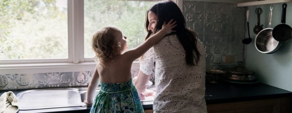 mother and daughter washing dishes